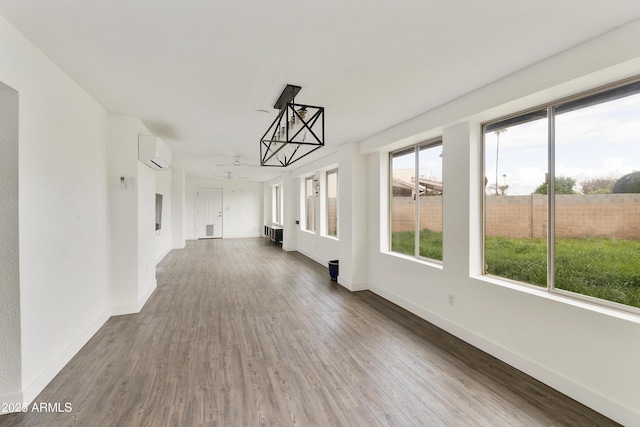 unfurnished sunroom with a wall mounted air conditioner