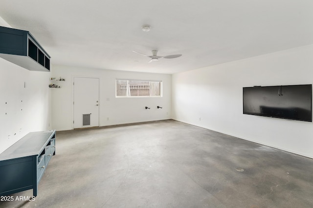 unfurnished living room featuring concrete floors and a ceiling fan