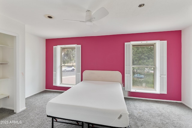 carpeted bedroom featuring baseboards and ceiling fan