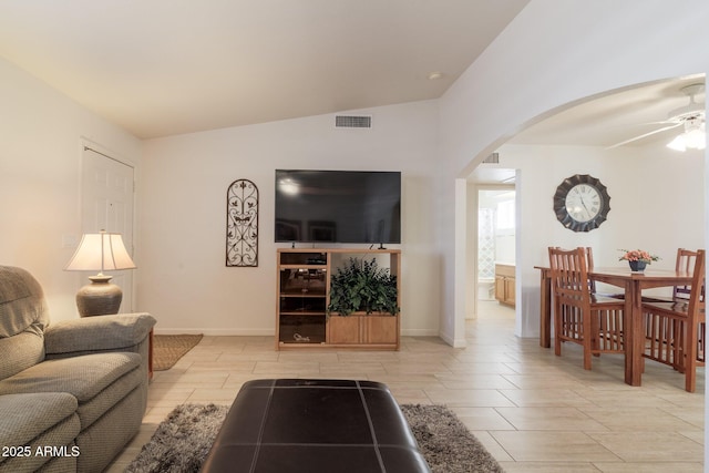 living room featuring ceiling fan and vaulted ceiling