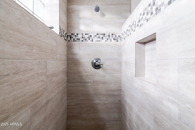 bathroom with a tile shower