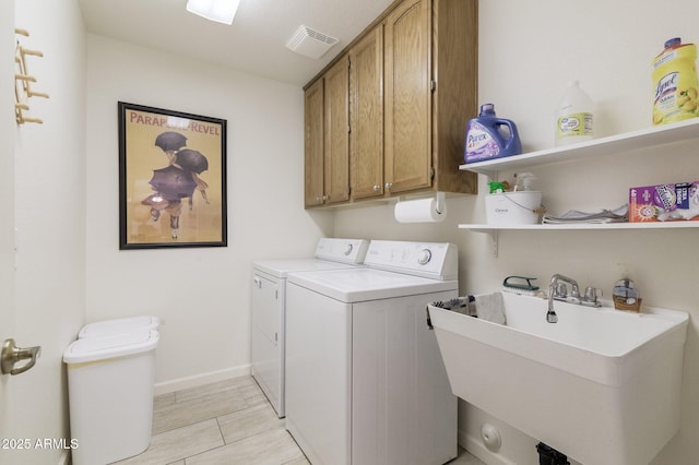 laundry room with cabinets, separate washer and dryer, and sink