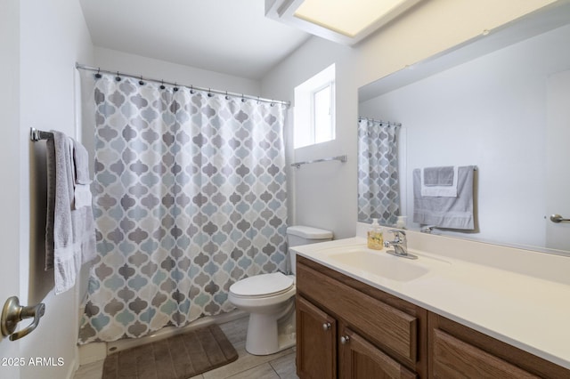 bathroom with toilet, vanity, a shower with curtain, and tile patterned floors