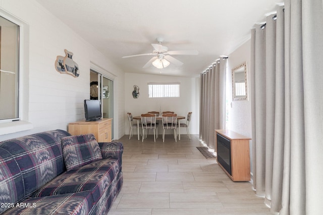 living room with ceiling fan and lofted ceiling