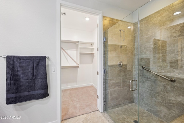 bathroom with tile patterned floors and a shower with shower door