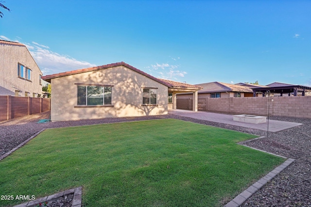 rear view of property with a lawn and a patio area