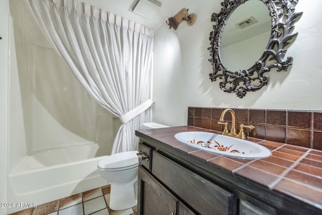 full bathroom featuring vanity, backsplash, tile patterned floors, toilet, and shower / bath combo with shower curtain