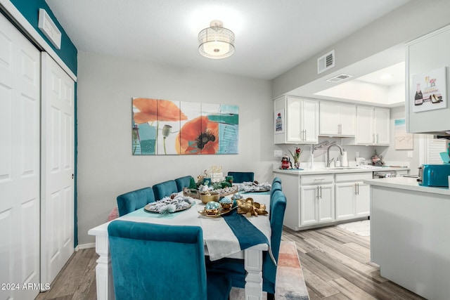 dining space featuring light hardwood / wood-style floors and sink