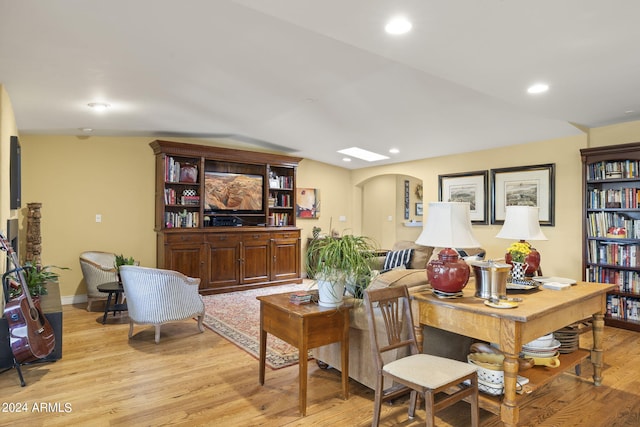 living room featuring light hardwood / wood-style floors and lofted ceiling