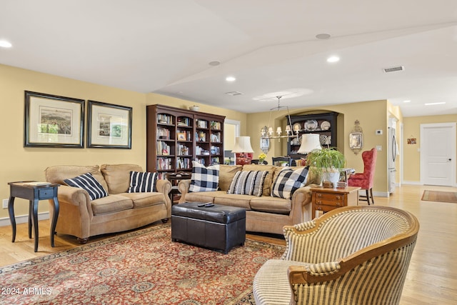 living room featuring an inviting chandelier and hardwood / wood-style flooring