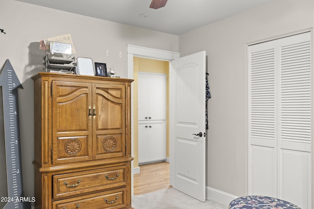 carpeted bedroom with a closet and ceiling fan