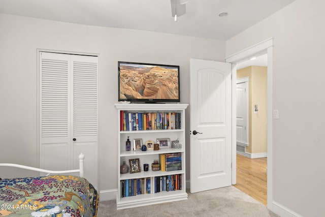 carpeted bedroom with a closet and ceiling fan