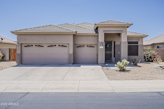 43319 W Oakland Ct, Maricopa, AZ 85138 - prairie-style home featuring a garage, stucco siding, driveway, and a tiled roof
