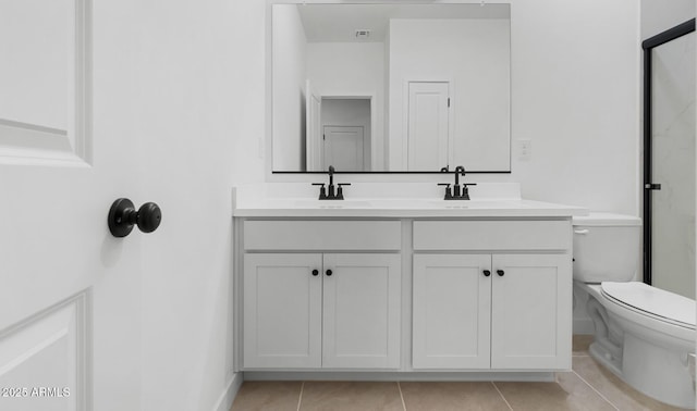 bathroom with vanity, tile patterned floors, and toilet