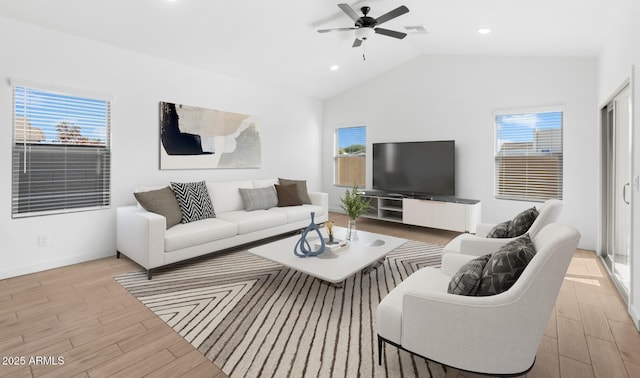 living room with vaulted ceiling, ceiling fan, and light wood-type flooring