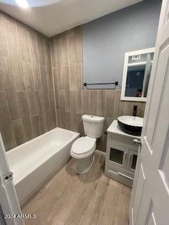 bathroom featuring vanity, hardwood / wood-style floors, and toilet