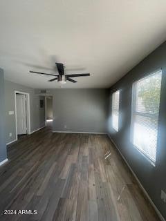 empty room featuring ceiling fan and dark hardwood / wood-style floors