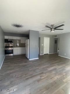 unfurnished living room with dark wood-type flooring and ceiling fan