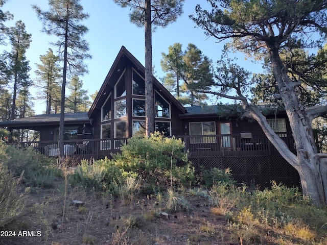 rear view of house featuring a deck