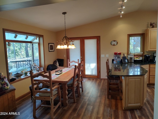 dining room with dark wood-type flooring, lofted ceiling, a wealth of natural light, and an inviting chandelier