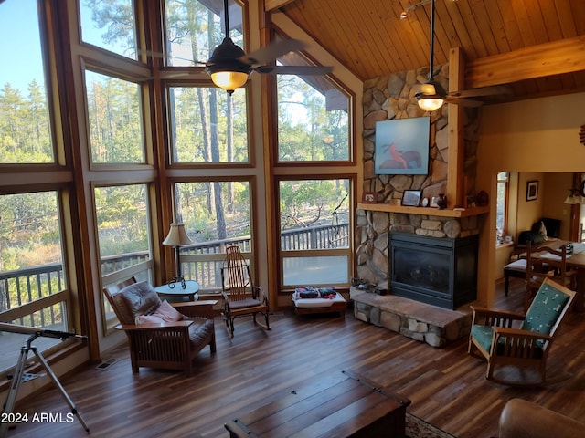 living room featuring dark wood-type flooring, high vaulted ceiling, and plenty of natural light