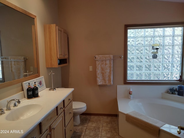 bathroom featuring vanity, tile patterned flooring, toilet, and a bathing tub