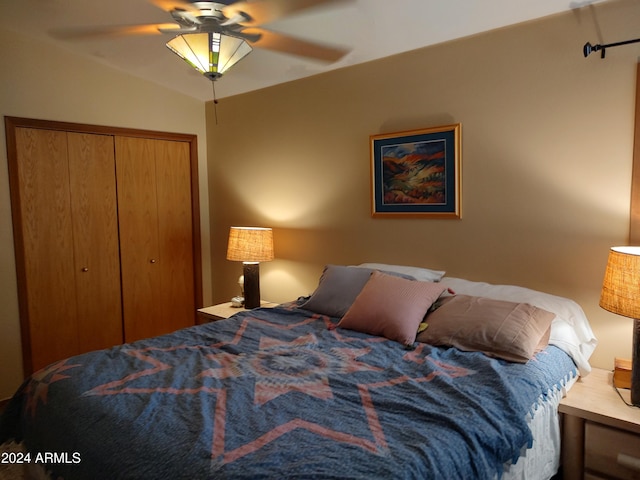 bedroom with a closet, ceiling fan, and vaulted ceiling