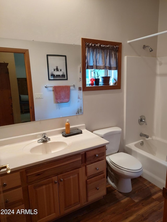 full bathroom with vanity, hardwood / wood-style floors, toilet, and tub / shower combination