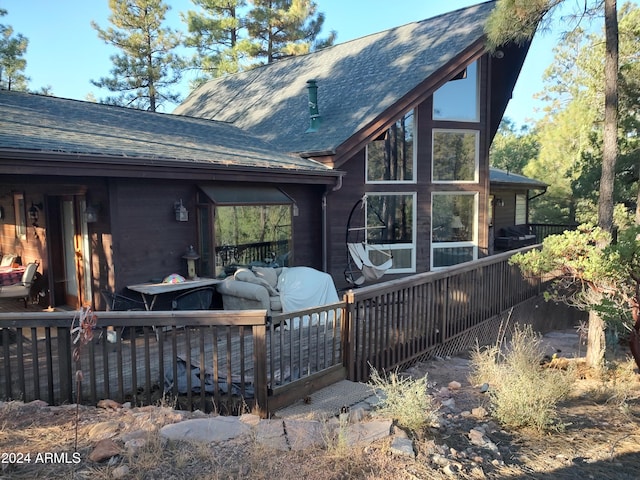 back of property with a wooden deck