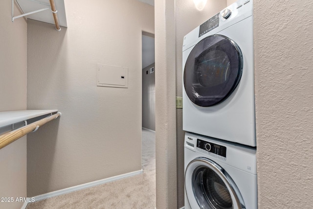 3434 E Baseline Rd Unit 126, Phoenix, AZ 85042 - washroom with estacked washer and dryer, carpet, and a textured wall