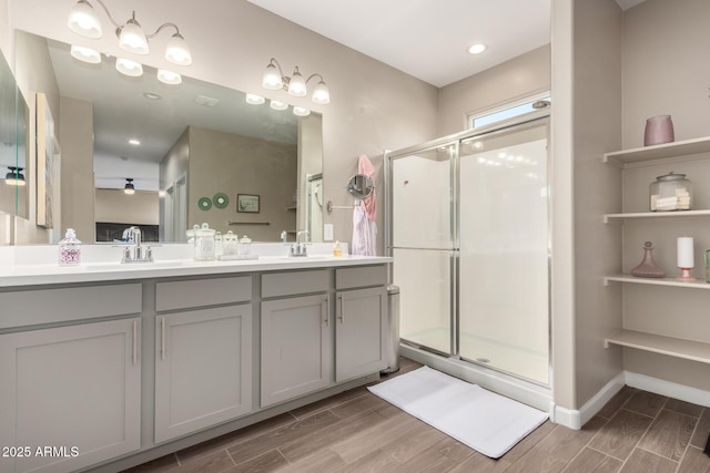 1297 W Chillingham Rd W, San Tan Valley, AZ 85143 - full bath with wood finished floors, double vanity, a shower stall, and baseboards