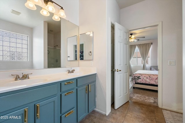 ensuite bathroom featuring double vanity, visible vents, connected bathroom, a shower stall, and a sink