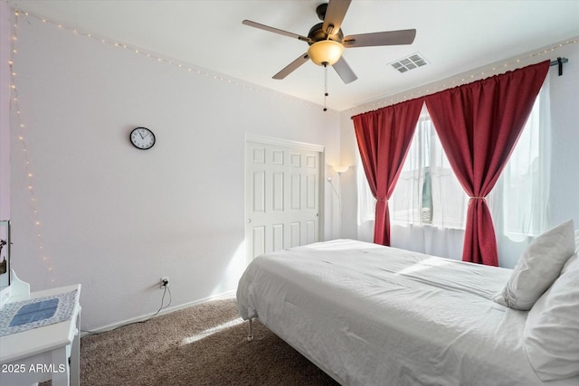 bedroom with carpet floors, baseboards, visible vents, and a ceiling fan