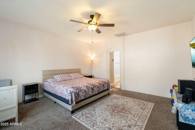 bedroom with dark colored carpet, visible vents, and a ceiling fan