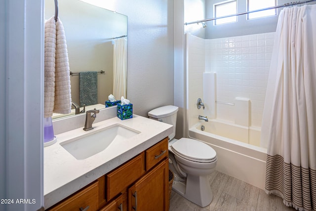 full bathroom featuring vanity, shower / tub combo, and toilet