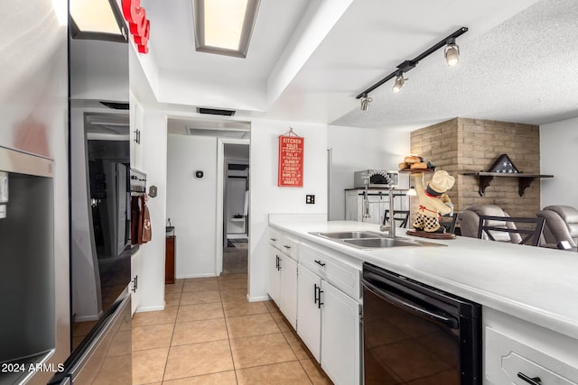 kitchen with light tile patterned flooring, rail lighting, sink, dishwasher, and white cabinetry