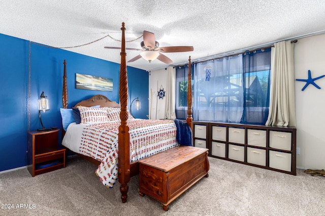 carpeted bedroom featuring a textured ceiling and ceiling fan