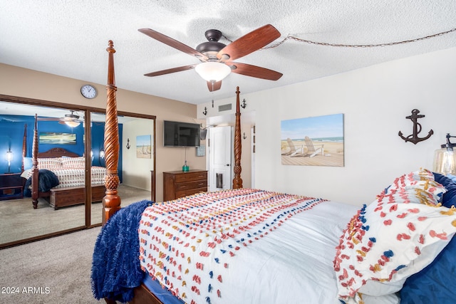 carpeted bedroom with a closet, a textured ceiling, and ceiling fan