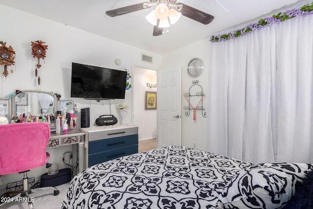 tiled bedroom featuring ceiling fan