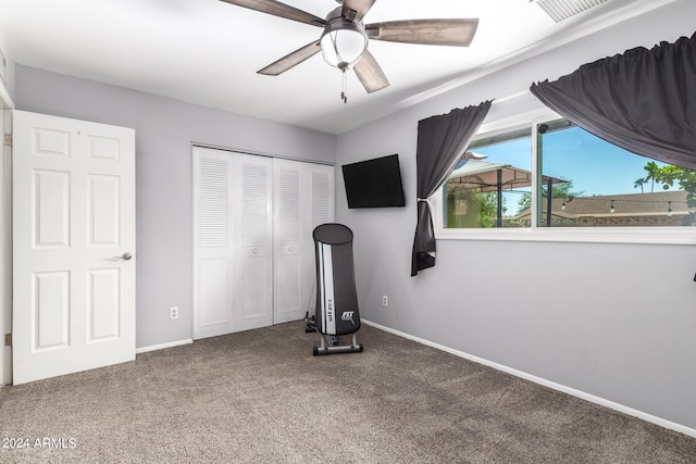 workout area featuring ceiling fan and carpet flooring