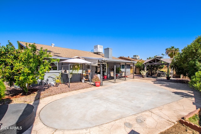 rear view of house featuring a gazebo and a patio