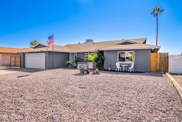 ranch-style house featuring cooling unit and a garage