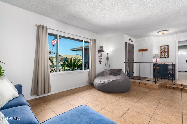 living area with light tile patterned floors and a textured ceiling