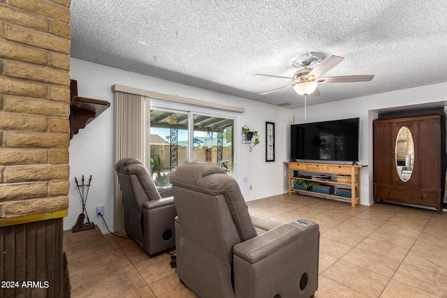 tiled living room featuring a textured ceiling and ceiling fan