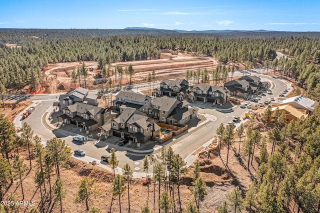 birds eye view of property with a wooded view and a residential view