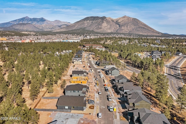 drone / aerial view featuring a residential view and a mountain view