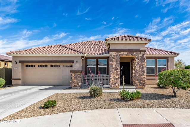 view of front facade featuring stone siding, stucco siding, concrete driveway, an attached garage, and a tile roof