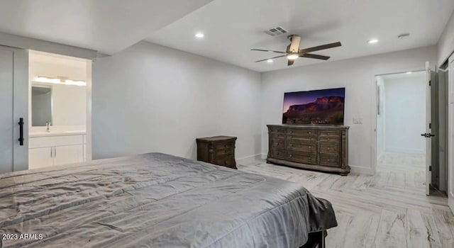 bedroom with ensuite bathroom, light parquet floors, ceiling fan, and sink