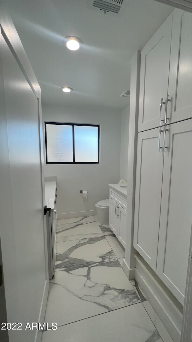 bathroom with vanity and toilet