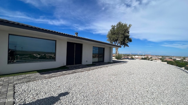 back of property with a patio